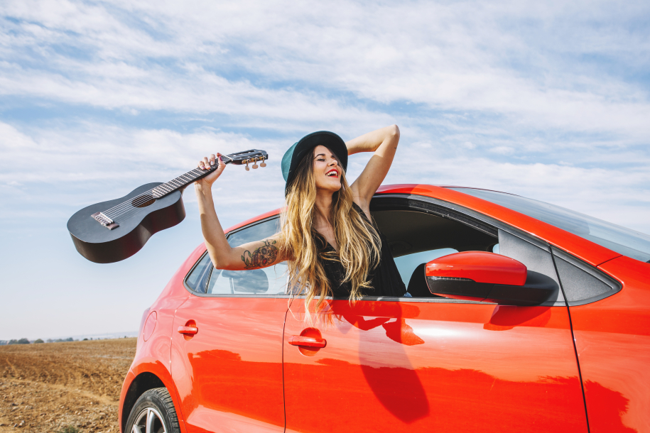 cheerful-woman-with-ukulele-car