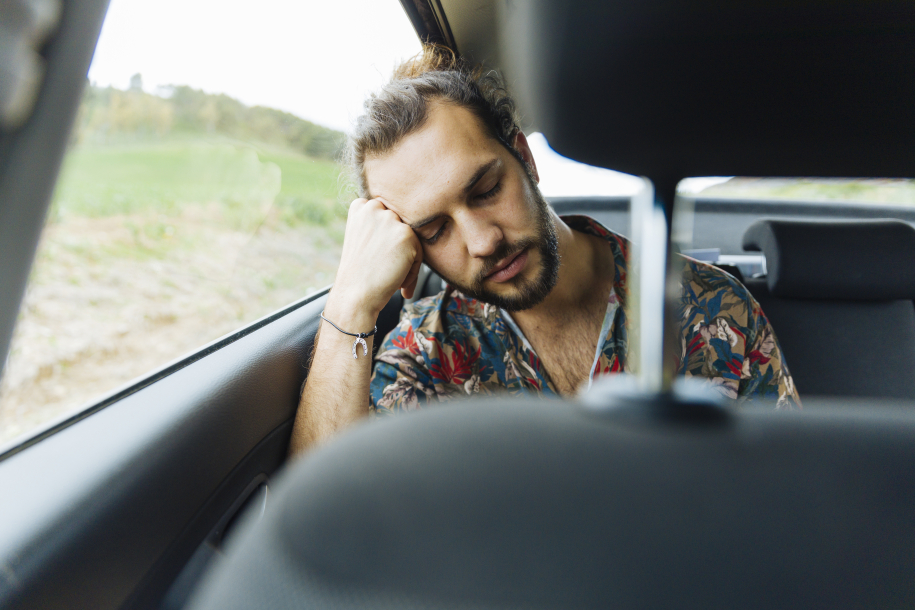 male-sleeping-back-seat-car