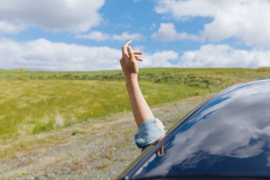 woman-hand-against-backdrop-nature