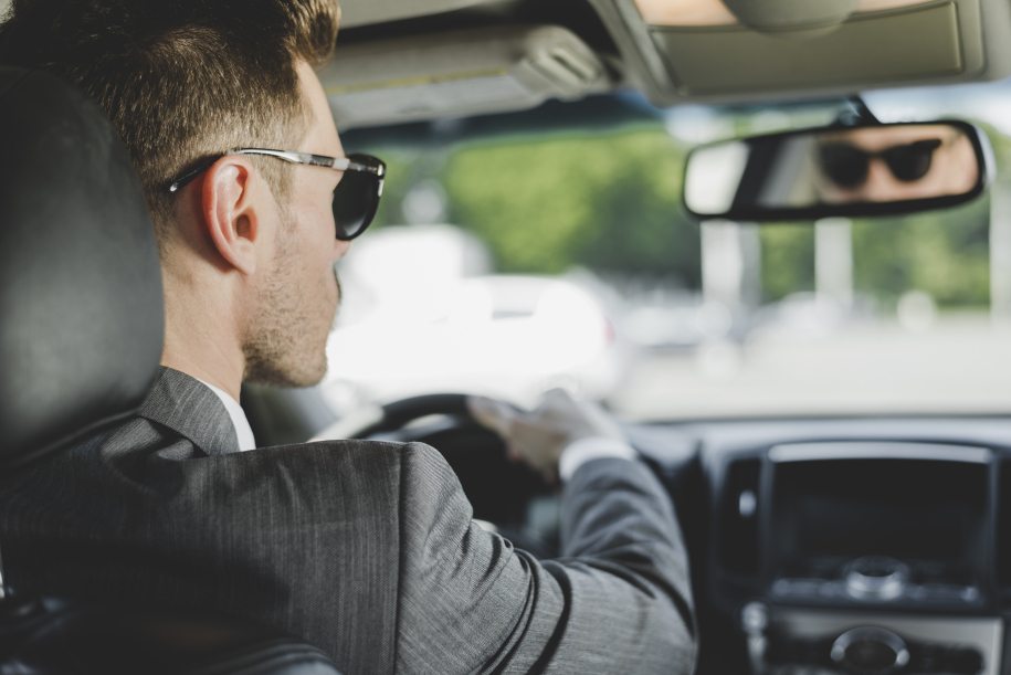 handsome-man-wearing-sunglasses-looking-rearview-mirror-car