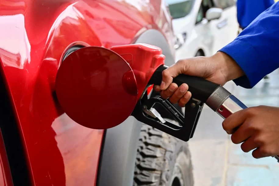 petrol station worker taking petrol