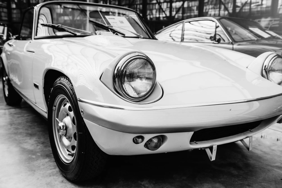 closeup of the headlights and front bumper on vintage automobile